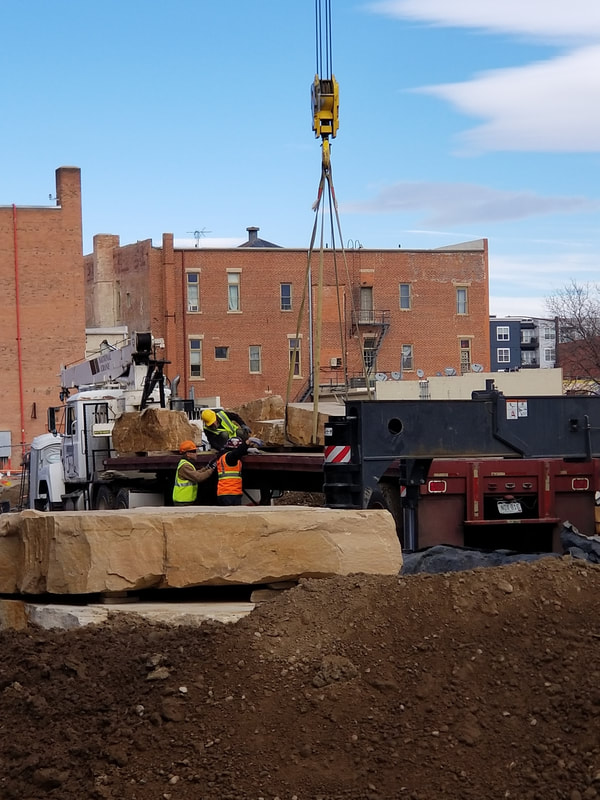 Update 11/16/2018: Today was a huge step in the installation of The Legacy Project. Over 68,000 lbs of Dakota sandstone was craned into the site and set by Denny Haskew and the National Sculptors' Guild. Next week the final stone and bronze element will be placed.

The Rotary Club of Thompson Valley's "Legacy Project" will activate the plaza of The Foundry, a new development that is transforming Loveland's historic downtown. The installation includes "Reaching Our Goal" bronze sculpture by National Sculptors' Guild Charter Member Denny Haskew
