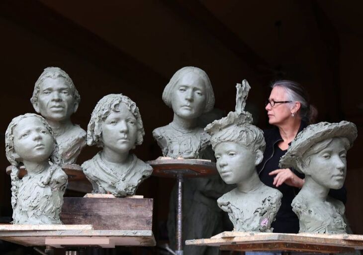 Jane with the clay busts of the commemorated women for the monument. 