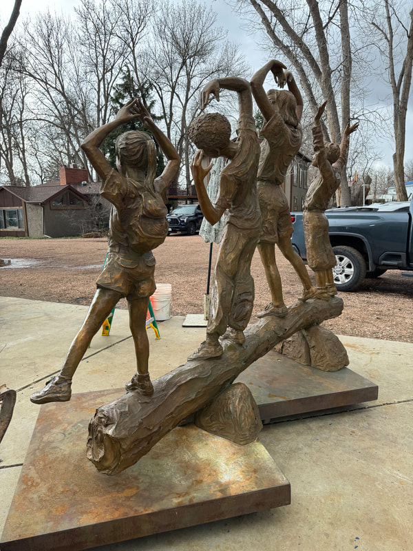 Update  4/1/2024: Jane and August have been busy finishing two large-scale pieces at DeDecker Studio. We love the warmth of the patina on YMCA. It really brings the piece to life and highlights the joyful faces.