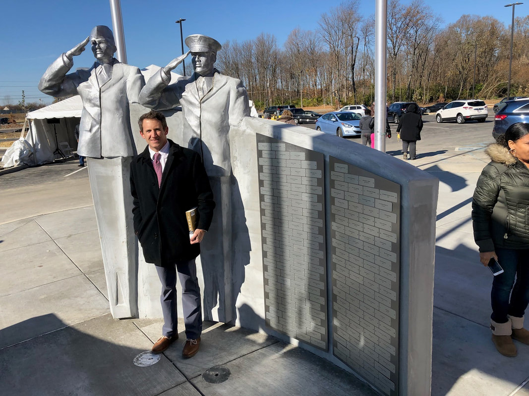 National Sculptors' Guild Fellow Clay Enoch with Salute at OrthoIndy Y at Pike, Indianapolis, IN during the dedication on November 10th 2018.  Update 11/10/18: Mother Nature has continued to send rain, so there's some touch ups to come. But the dedication was well attended and we are pleased to be involved in honoring our Veterans. #WeSaluteYou