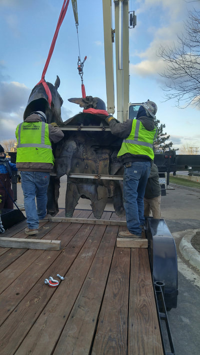 John Kinkade and Denny Haskew of the National Sculptors' Guild are in Shakopee, MN to install Chief Shakopee at the entrance of the city . 

Working quickly this morning in 27-degree temps, the NSG and Shakopee team secured the 7-foot by 9-foot bronze bas-relief to it's new home. 

Denny was inspired by a quote from Chief Sakpe, "Over these hills I once rode free upon my horse."  The sculpture shows Sakpe standing next to his horse overlooking the land. 

The Shakopee Mdewakanton Sioux Community is a federally recognized, sovereign Indian tribe of Mdewakanton Dakota people, located southwest of Minneapolis and Saint Paul, within parts of the cities of Prior Lake and Shakopee. Mdewakanton, pronounced Mid-ah-wah-kah-ton, means "dwellers at the spirit waters." Tribal members are direct lineal descendants of Mdewakanton Dakota people who resided in villages near the banks of the lower Minnesota River. A line of leaders known as Chief Sakpe were spokesmen for their village. The first Sakpe pronounced Shock-pay, meaning "six," was named by his people as such after his wife bore sextuplets. The City of Shakopee later developed near this site and was named for these prominent leaders. 