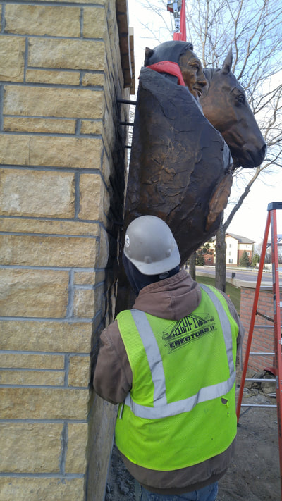 John Kinkade and Denny Haskew of the National Sculptors' Guild are in Shakopee, MN to install Chief Shakopee at the entrance of the city . 

Working quickly this morning in 27-degree temps, the NSG and Shakopee team secured the 7-foot by 9-foot bronze bas-relief to it's new home. 

Denny was inspired by a quote from Chief Sakpe, "Over these hills I once rode free upon my horse."  The sculpture shows Sakpe standing next to his horse overlooking the land. 

The Shakopee Mdewakanton Sioux Community is a federally recognized, sovereign Indian tribe of Mdewakanton Dakota people, located southwest of Minneapolis and Saint Paul, within parts of the cities of Prior Lake and Shakopee. Mdewakanton, pronounced Mid-ah-wah-kah-ton, means "dwellers at the spirit waters." Tribal members are direct lineal descendants of Mdewakanton Dakota people who resided in villages near the banks of the lower Minnesota River. A line of leaders known as Chief Sakpe were spokesmen for their village. The first Sakpe pronounced Shock-pay, meaning "six," was named by his people as such after his wife bore sextuplets. The City of Shakopee later developed near this site and was named for these prominent leaders. 