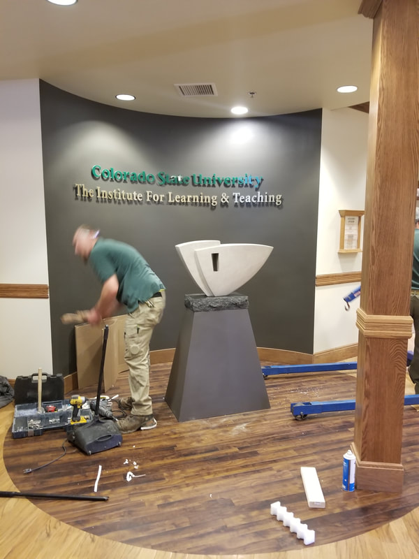 June 2018: Colorado State University has selected NSG Fellow Kathleen Caricof to create a sculpture honoring Alan Lamborn who retired from a 34-year career with CSU.

In designing the artwork, Caricof worked with the primary theme of the celebration of education, showing the importance of education as a foundation for the future.
​
The selected design, "Onward" is a sculpted stone representing the individual whose heart remains open to learning. A carved arrow points in the direction of growth.


NSG Public Art Placement 504