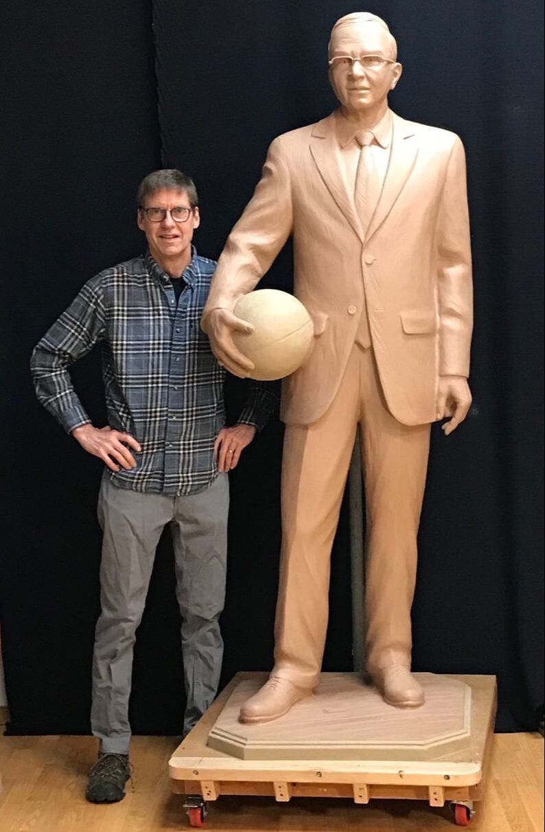 National Sculptors' Guild Fellow Gary Alsum has been selected to sculpt Gene Bess for placement at Three Rivers College in Poplar Bluff, Missouri. Coach Bess won a record 1,300 wins in 50 seasons as Three Rivers head coach while teaching two classes a semester, and serving as the Three Rivers Athletic Director throughout his career. At least 42 former players for Bess have gone on to coach all over the country. He became college basketball’s all-time wins leader in 2001 when he surpassed North Carolina’s Dean Smith and Richard Baldwin of Broome Community College. He was the first college basketball coach to reach 1,000 wins in 2006, the first with 1,100 wins four seasons later, and 1,200 in 2015. His 1,300th win came in what ended up being his final home game on a court named in his honor. Coach Bess finished with a career record of 1,300-416, won national championships in 1979 and 1992, coached in four national title games, appeared in 17 national tournaments, won 23 region championships, and is a member of four halls of fame. “He brought notoriety, he brought fame, he brought championships, but that’s not the important thing that he brought to our school,” Three Rivers President Dr. Wesley Payne said. “He brought honor. He brought a dedication that was an example to everyone that works there or walked through the doors as a student. He brought courage, he brought direction, he brought an example that was worthy to follow.”  The school has been hard at work raising funds for this commemorative sculpture.  The bronze will be a life-sized standing figure depicting the coach with basketball in hand wearing his familiar suit and tie. The sculpture will be located on the entry plaza of the Libla Family Sports Center in 2022.  The former coach of the men's basketball team at Three Rivers Community College was hired in 1971.  ​His career win-loss record is 1,300-416 (.757 winning percentage), making him the all-time winningest college basketball coach.  In his time at Three Rivers, he won two national junior college basketball titles, in 1979 and 1992, and was the first college coach to reach 1,000 and 1,200 wins. Bess coached NBA player Latrell Sprewell at Three Rivers. Bess announced his retirement from coaching in May 2020 after suffering from health problems during his final years on the bench.
