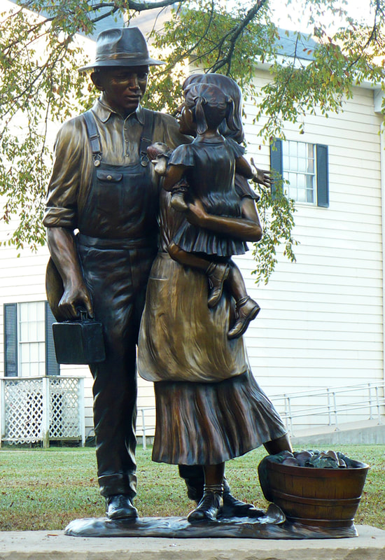 “A Prosperous Past, a Bright Future” by Fellow Gary Alsum and the National Sculptors' Guild was placed in Brighton, CO at Bridge St and Cabbage Ave.

​The public artwork features two sculptural elements. The first element speaks to Brighton’s rich history and sense of family. The piece depicts a father, mother and young daughter. The father’s occupation is vague so that the viewer could see him as a farmer, a miner or any profession that made Brighton what it is today. On the ground next to the mother’s foot is a basket of vegetables, a nod to Brighton’s agricultural past and future. The second element connects to the city’s current boom and its continued success in the future. This sculpture depicts a young boy, playing with a train and a toy airplane. The train is symbolic of Brighton’s past. The airplane is symbolic of Brighton’s steady economic growth as a result of its proximity to DIA. Gary states that “The challenge of sculpture is depicting the movement and energy of a single moment.” Placing a great deal of focus on movement and grace, Gary’s sculptures pass on the freedom, joy and curiosity that children display on a daily basis. ​

NSG Public Art Placement #287