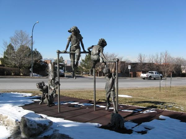 The National Sculptors' Guild placed Fellow Jane DeDecker's "Jungle Gym" in Westminster, Colorado in 1995. The 125% life-size multi-figurative bronze features five-children at play on a jungle gym, joined in by a dog tugging at the laces of one of the kids. The piece is a reminder of simpler days of play in parks and schools. 

The sculpture measures 11ft tall, 15ft wide, 5ft deep.

NSG public art placement 9